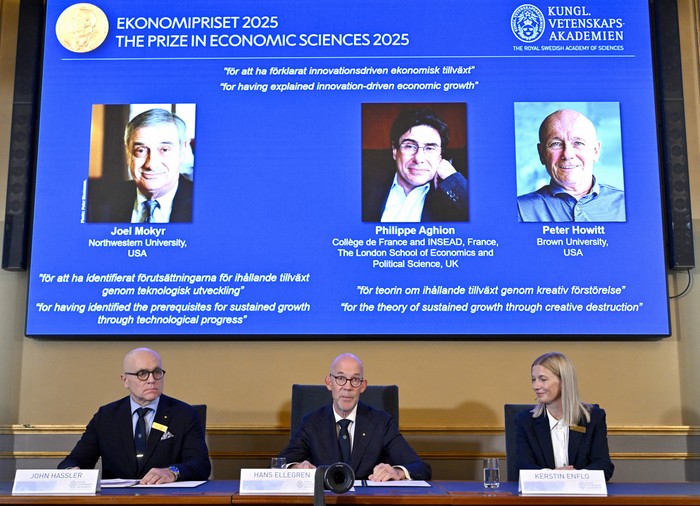 John Hassler, presidente del Comité del Premio en Ciencias Económicas en memoria de Alfred Nobel; el secretario general de la Real Academia Sueca de Ciencias, Hans Ellegren, y Kerstin Enflo, miembro del Comité del Premio en Ciencias Económicas, con los retratos de los ganadores del premio de 2025. · Foto: Anders Wiklund, Agencia TT, AFP John Hassler, presidente del Comité del Premio en Ciencias Económicas en memoria de Alfred Nobel; el secretario general de la Real Academia Sueca de Ciencias, Hans Ellegren, y Kerstin Enflo, miembro del Comité del Premio en Ciencias Económicas, con los retratos de los ganadores del premio de 2025. · Foto: Anders Wiklund, Agencia TT, AFP